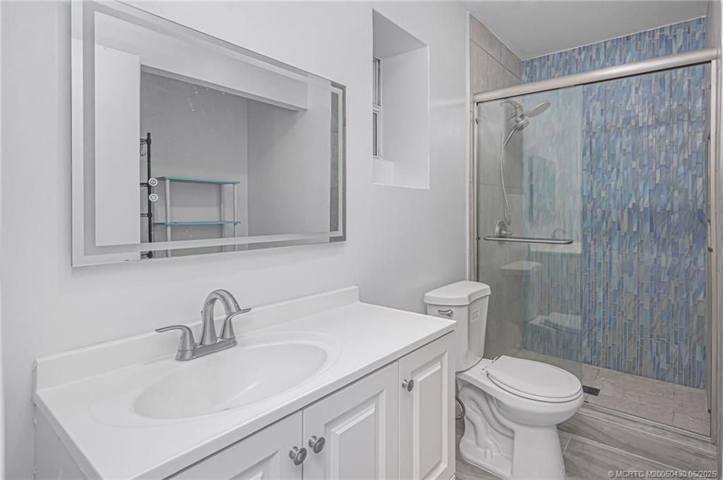 7007 South Indian River Drive Fort Pierce, FL 34982 - Photo 14 of 23 a bathroom with a sink toilet and shower