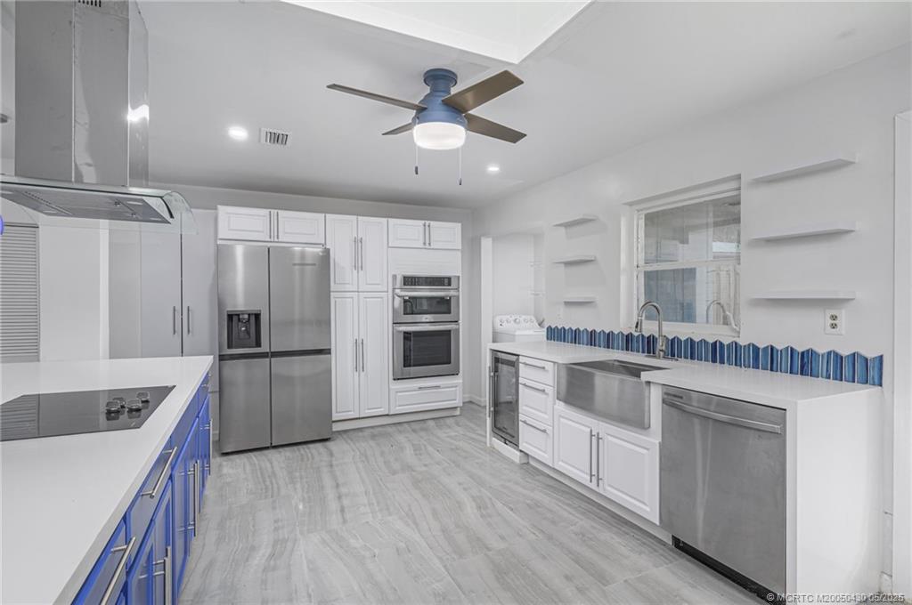 7007 South Indian River Drive Fort Pierce, FL 34982 - Photo 15 of 23 a kitchen with stainless steel appliances a stove a sink and a refrigerator