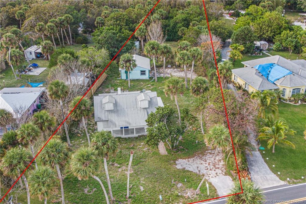 7007 South Indian River Drive Fort Pierce, FL 34982 - Photo 3 of 23 an aerial view of residential house with outdoor space and trees all around