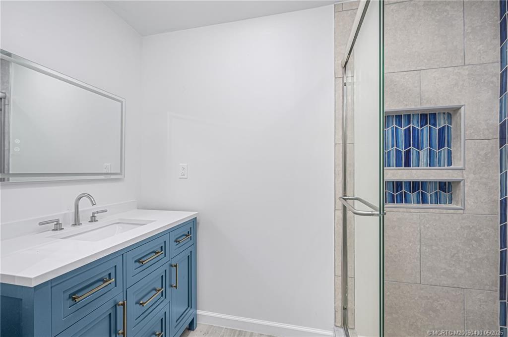 7007 South Indian River Drive Fort Pierce, FL 34982 - Photo 10 of 23 a bathroom with a sink and a mirror