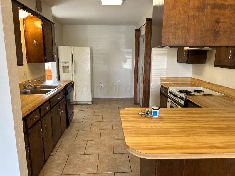 5719 Wabash Street Amarillo, TX 79109 - Photo 2 of 2 a bathroom with a sink and a mirror