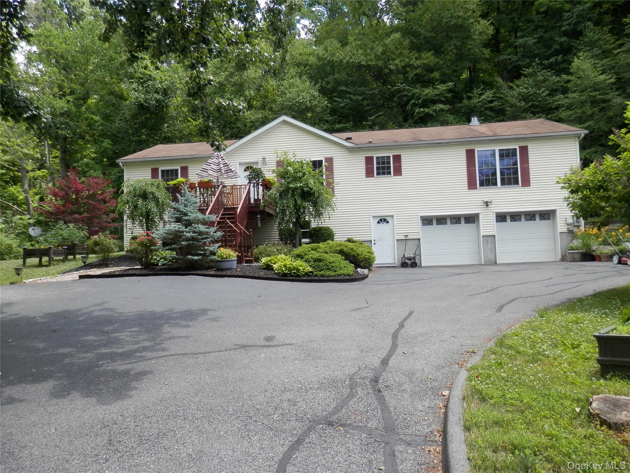 590 Farm To Market Road Brewster, NY 10509 - Photo 6 of 32 a front view of a house with a yard and garage