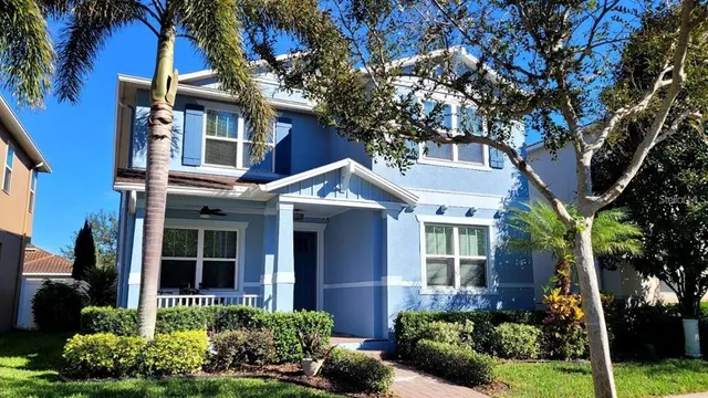 a front view of a house with plants and garden