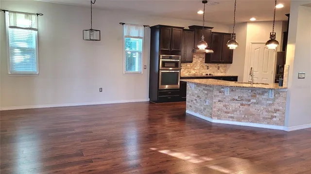 a view of a kitchen with cabinets and a wooden floor