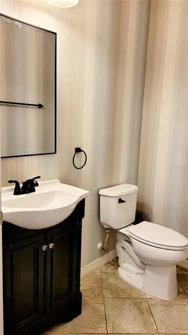 a bathroom with a sink a toilet and mirror