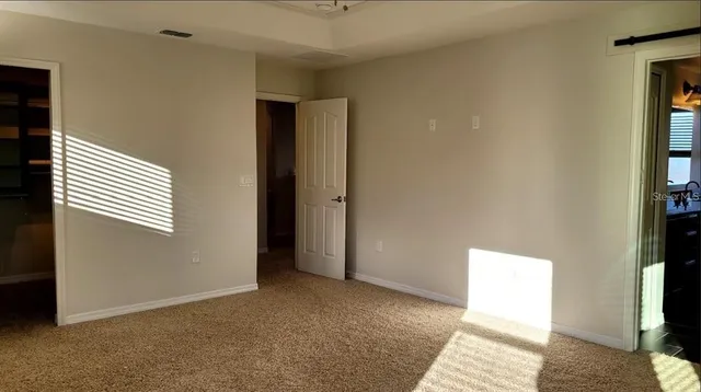 a view of an empty room with a window