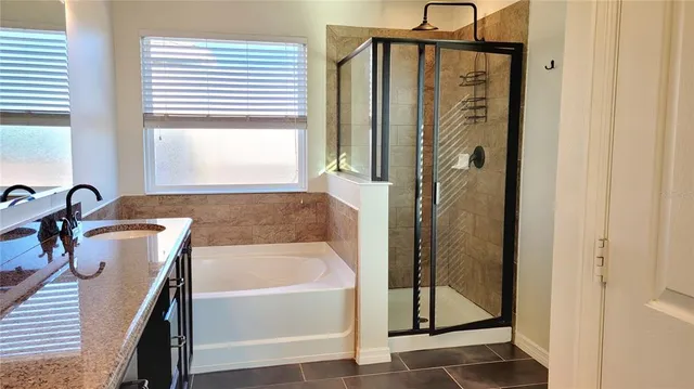 a bathroom with a bathtub and a shower