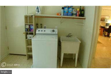 112 Gloucester Road Queenstown, MD 21658 - Photo 13 of 24 a utility room with a sink dryer and washer