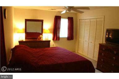 112 Gloucester Road Queenstown, MD 21658 - Photo 16 of 24 a bedroom with a bed and a television