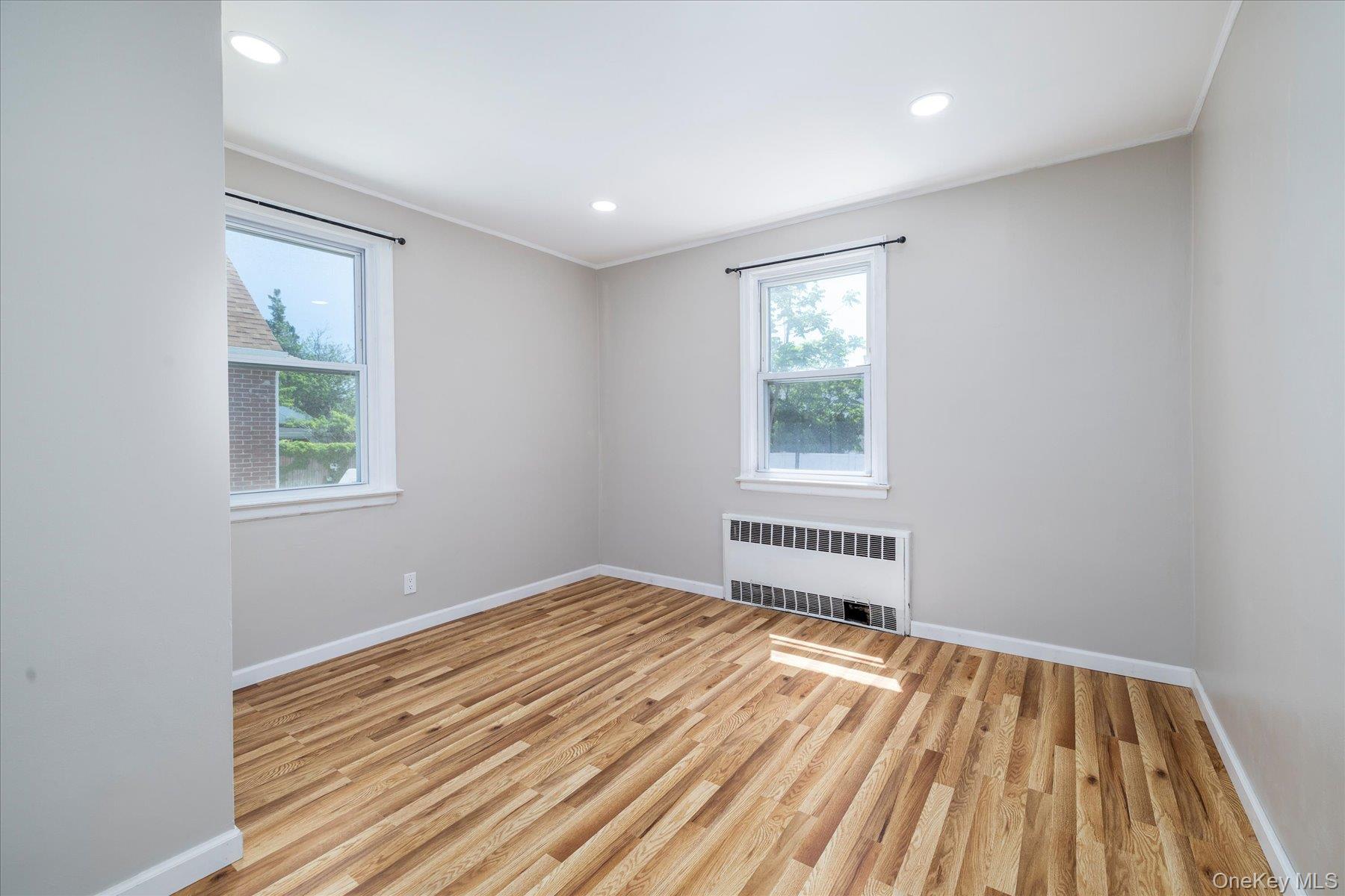 191 Raff Avenue Mineola, NY 11501 - Photo 16 of 25 a bedroom with a bed and a window