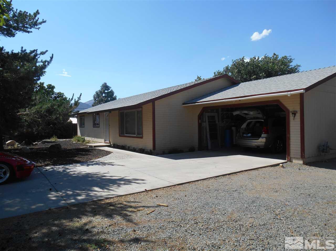 107 Ring Road Dayton, NV 89403 - Photo 1 of 1 a front view of a house with a yard and garage