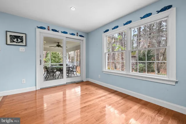 a bed sitting in a spacious bedroom next to a window