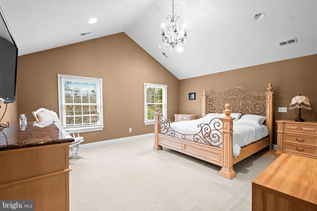 a bathroom with a granite countertop sink mirror and toilet