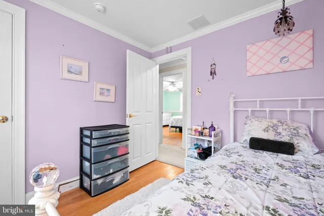 a view of a workspace with furniture and wooden floor