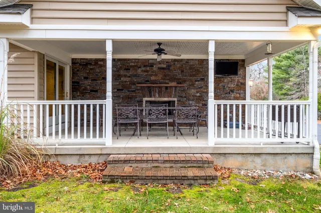an aerial view of a house with a yard basket ball court and outdoor seating