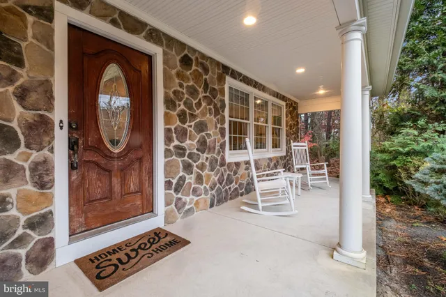 a view of an entryway with a table and a potted plant