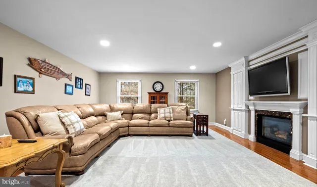 a living room with furniture fireplace and flat screen tv