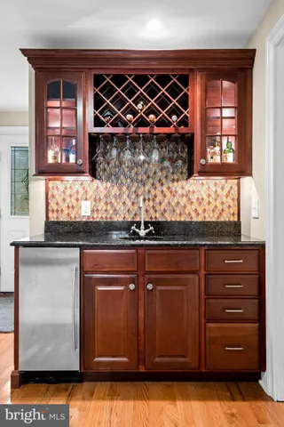 a kitchen with granite countertop wooden cabinets and granite counter tops