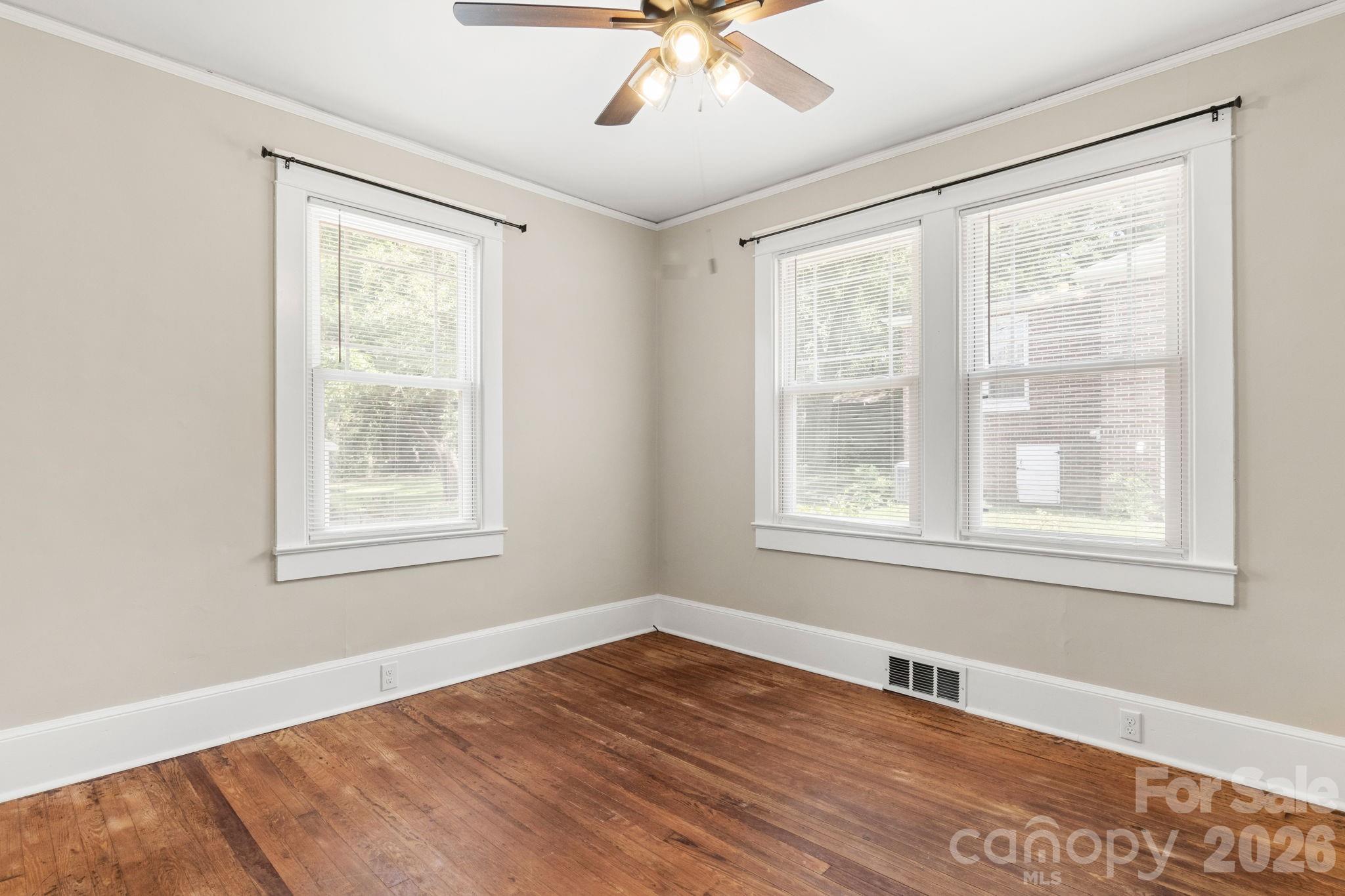 108 Reedy Street Chester, SC 29706 - Photo 22 of 42 a view of an empty room with wooden floor and a window
