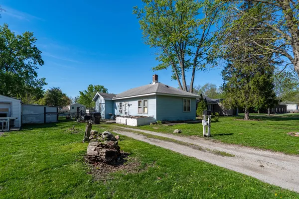 a house view with a sitting space and garden