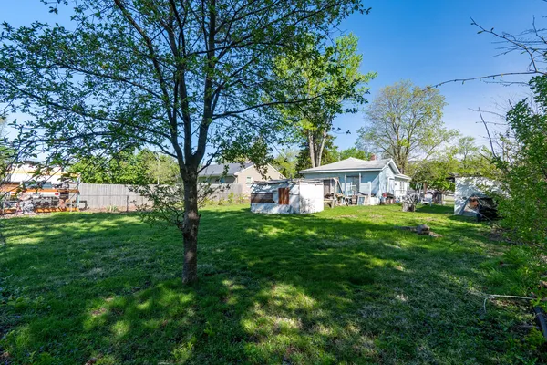 a view of an house with backyard space and garden
