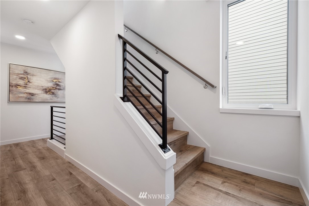 1324 East Spring Street Seattle, WA 98122 - Photo 20 of 29 a view of entryway with stairs and wooden floor