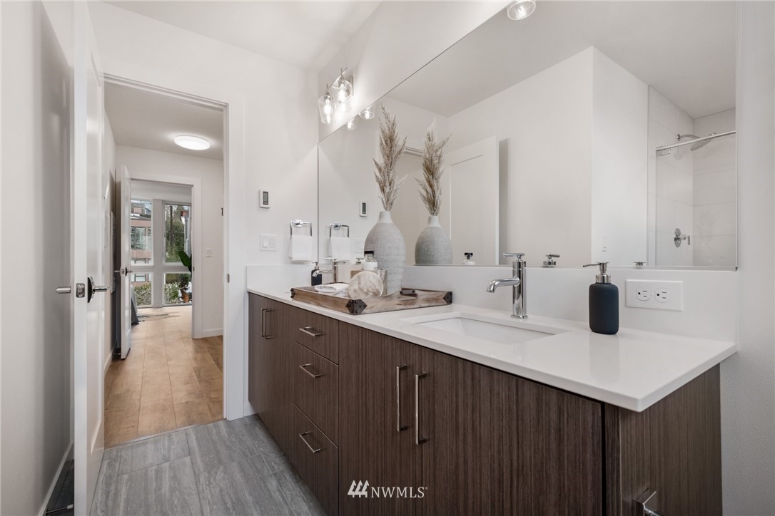 1324 East Spring Street Seattle, WA 98122 - Photo 23 of 29 a en suite bathroom with a sink and a mirror