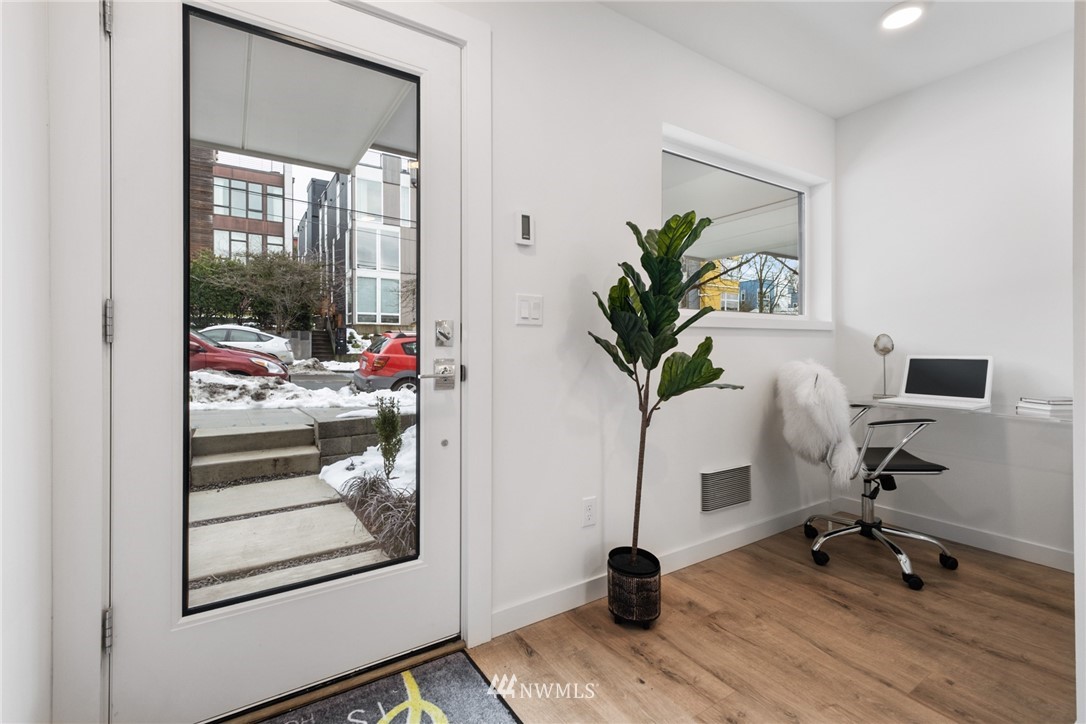 1324 East Spring Street Seattle, WA 98122 - Photo 4 of 29 a view of a workspace with furniture and a potted plant
