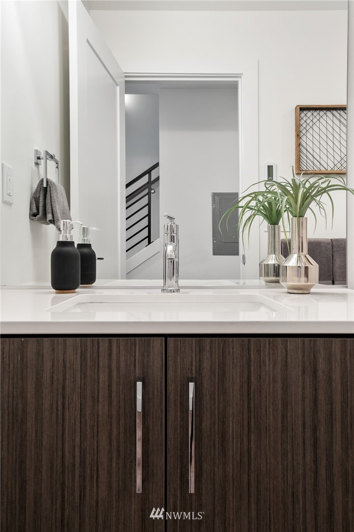 1324 East Spring Street Seattle, WA 98122 - Photo 6 of 29 a bathroom with a sink and a mirror