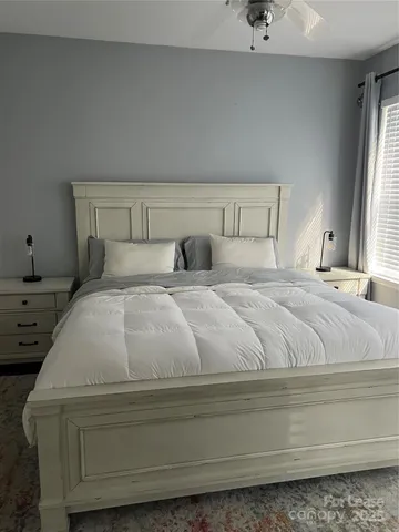 a bedroom with a bed and window