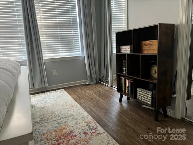 an entryway with wooden floor and a window