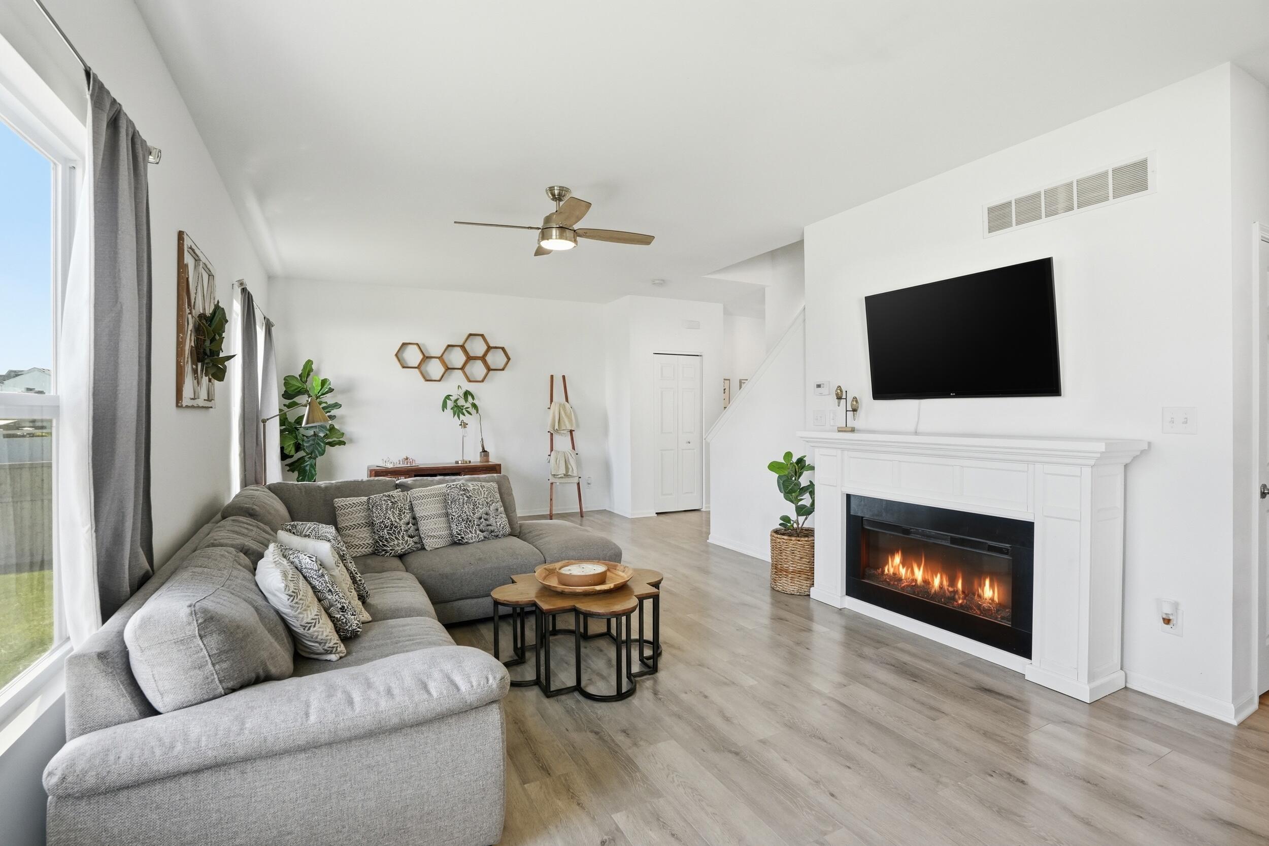 8658 Valley Forge Way Lowell, IN 46356 - Photo 5 of 23 a living room with furniture a fireplace and a flat screen tv