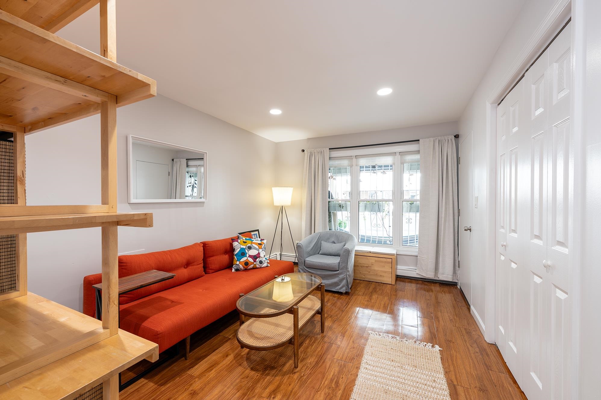 72 Henry Street, Unit 3AGARDEN Jersey City, NJ 07306 - Photo 4 of 13 a living room with furniture and a large window