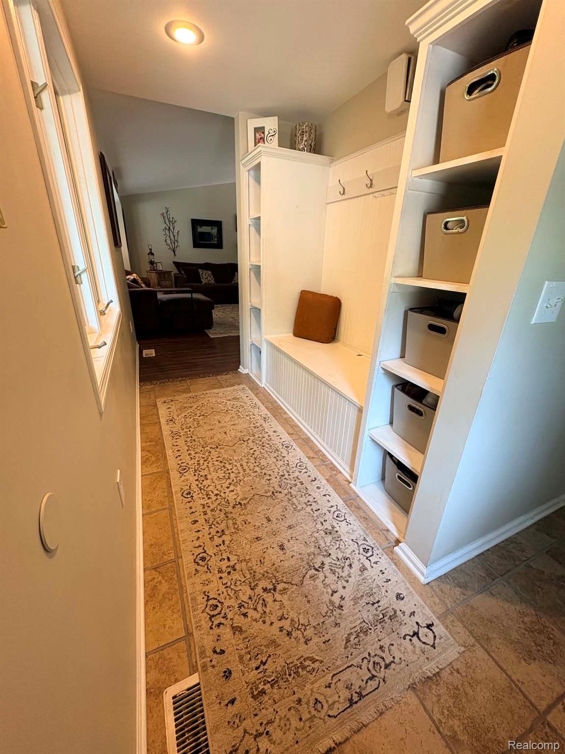 2159 East Bevens Road Caro, MI 48723 - Photo 11 of 38 Entryway featuring built-in white cabinetry, integrated bench seating, and wall-mounted coat hooks