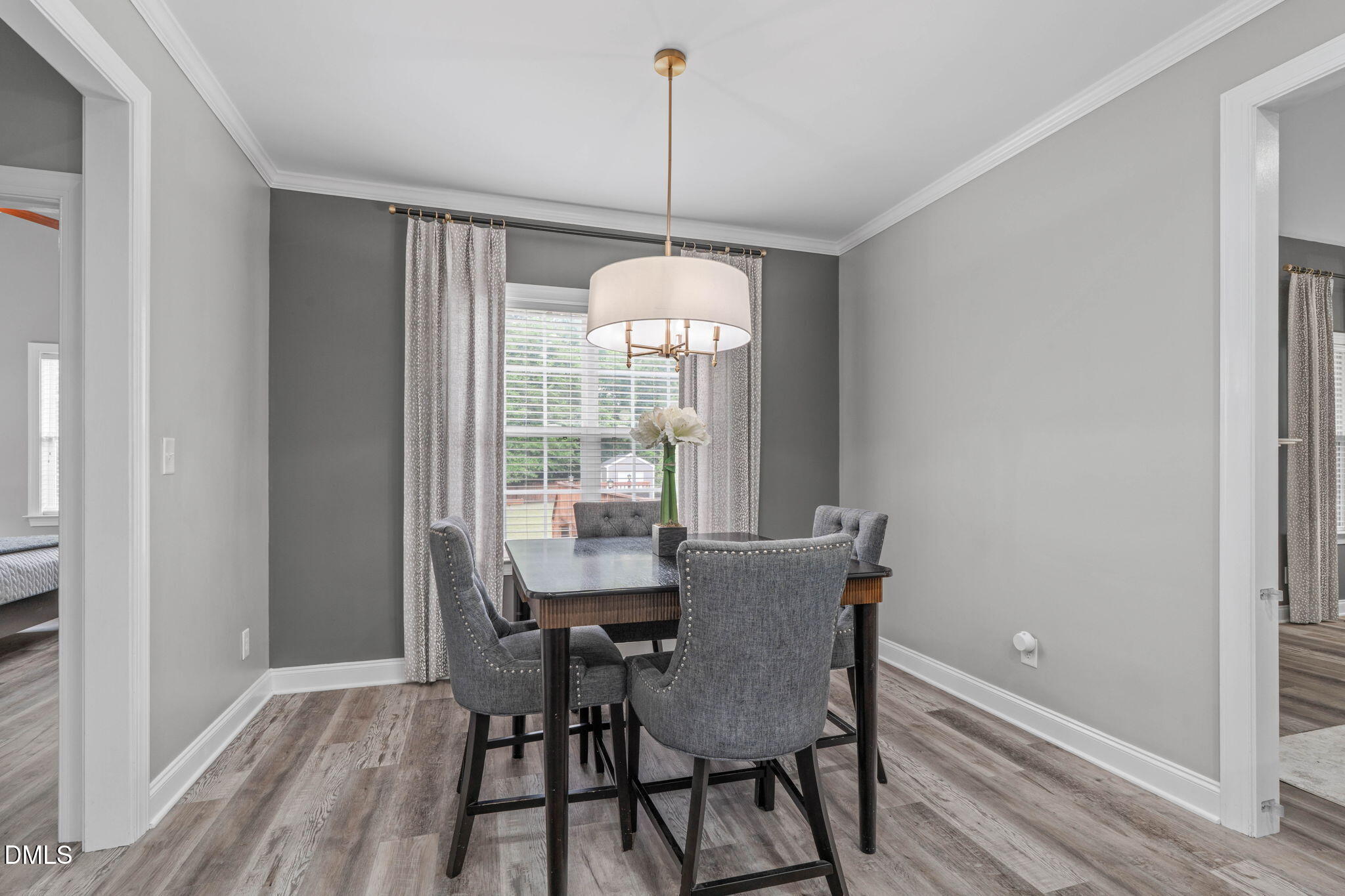 2450 Rolling Tracks Road Willow Spring, NC 27592 - Photo 18 of 64 a dining room with furniture window wooden floor and a chandelier
