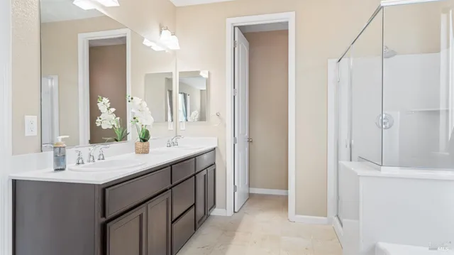a bathroom with a double vanity sink mirror and double
