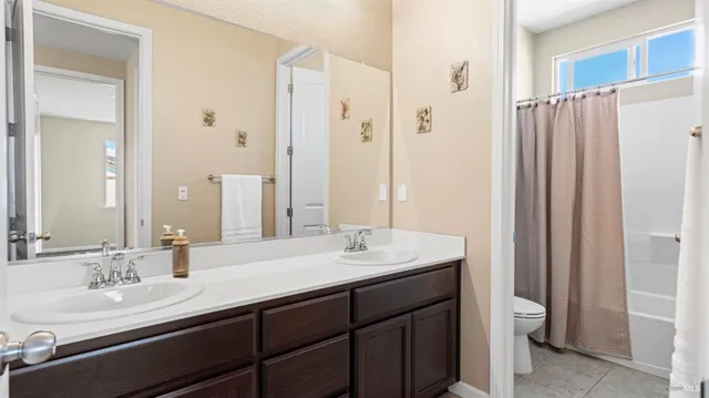 a bathroom with a double vanity sink and a mirror