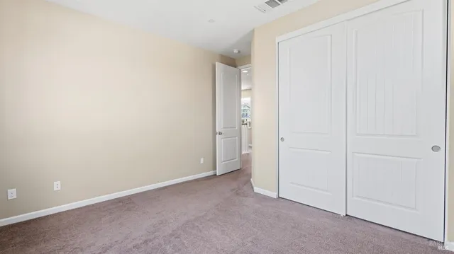 an empty room with closet area