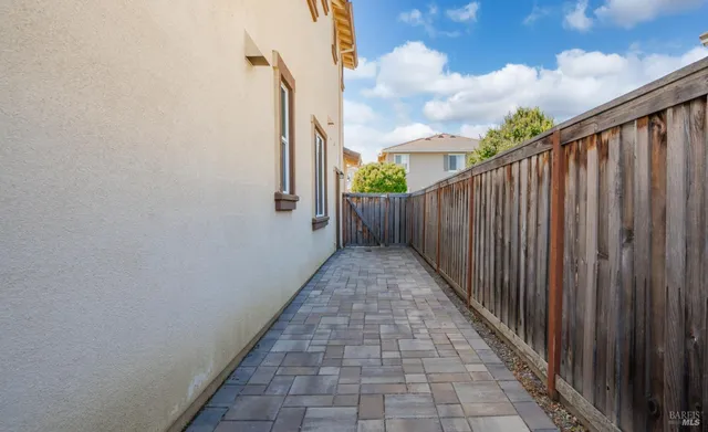 a view of a pathway of a wooden fence