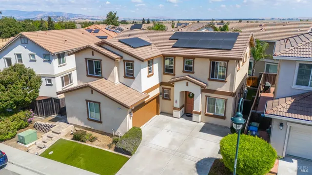 an aerial view of a house with a yard