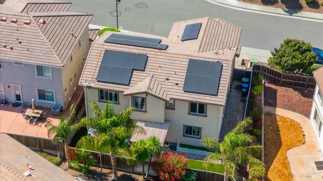 a view of a building with potted plants and a large tree