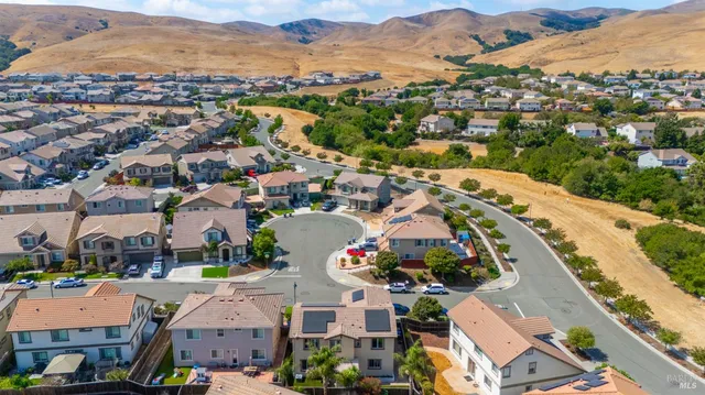 an aerial view of residential houses with outdoor space and river