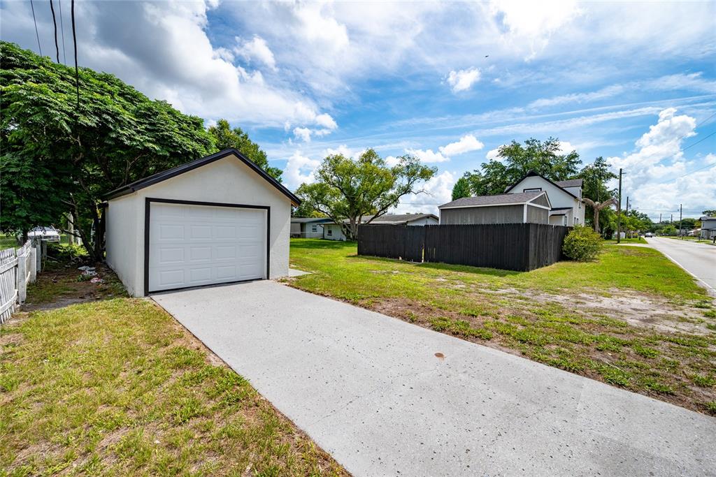 922 Delaware Avenue St. Cloud, FL 34769 - Photo 4 of 31 a view of a house with a yard and garage