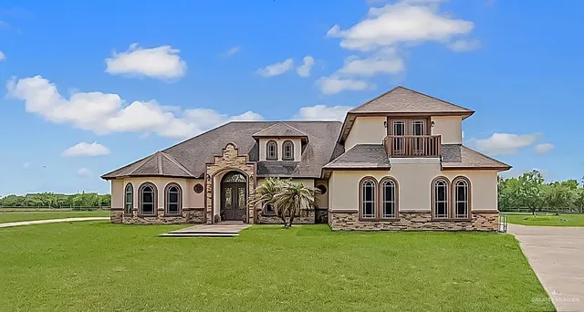 a front view of a house with swimming pool having outdoor seating