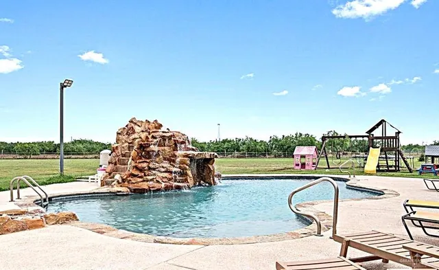a swimming pool with outdoor seating and yard