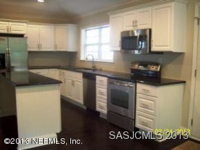 2807 Adams Road St. Augustine, FL 32092 - Photo 8 of 13 a kitchen with a refrigerator and a sink