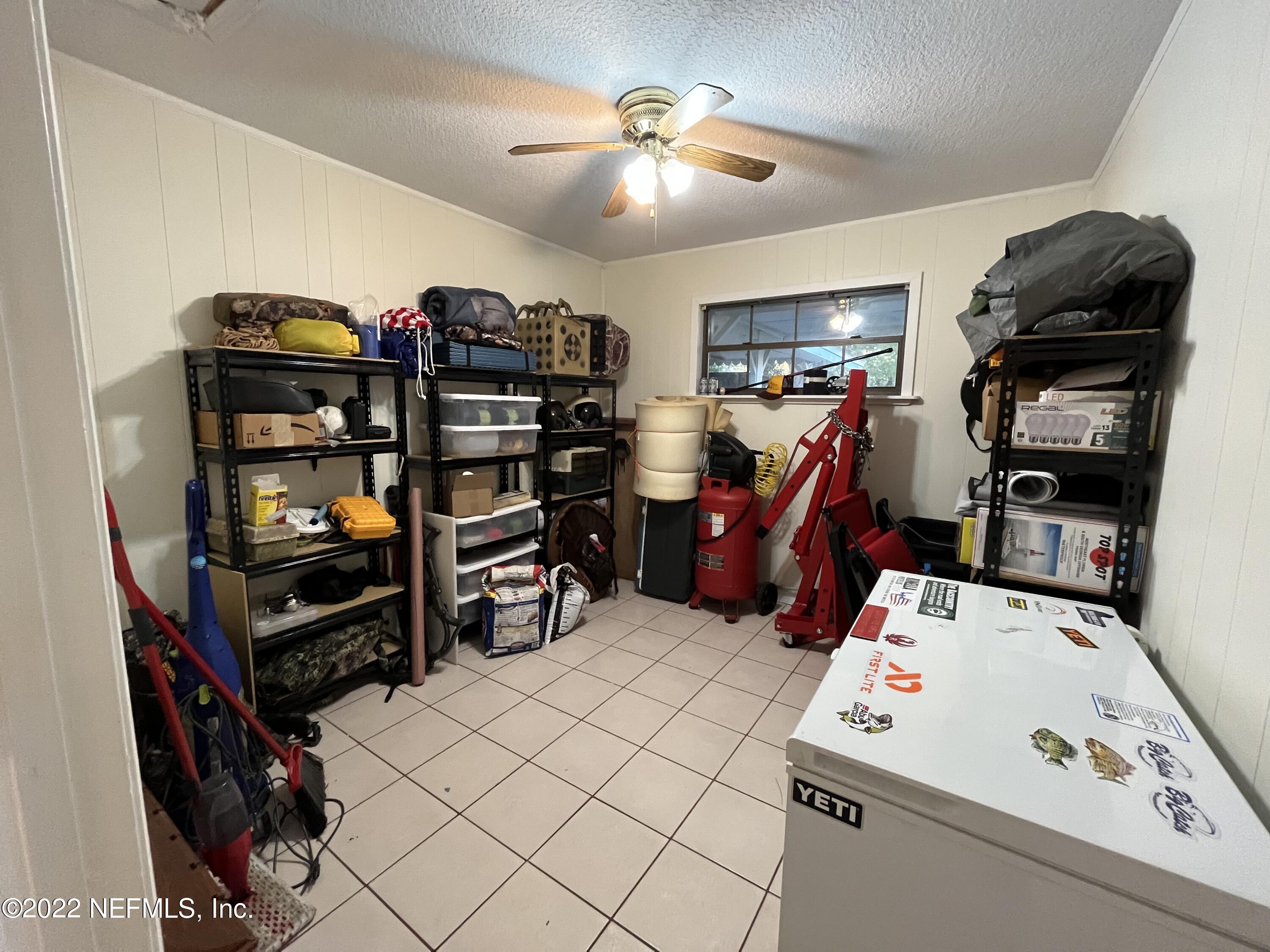 75049 Edwards Road Yulee, FL 32097 - Photo 11 of 23 a bed room with a bed and a book shelf