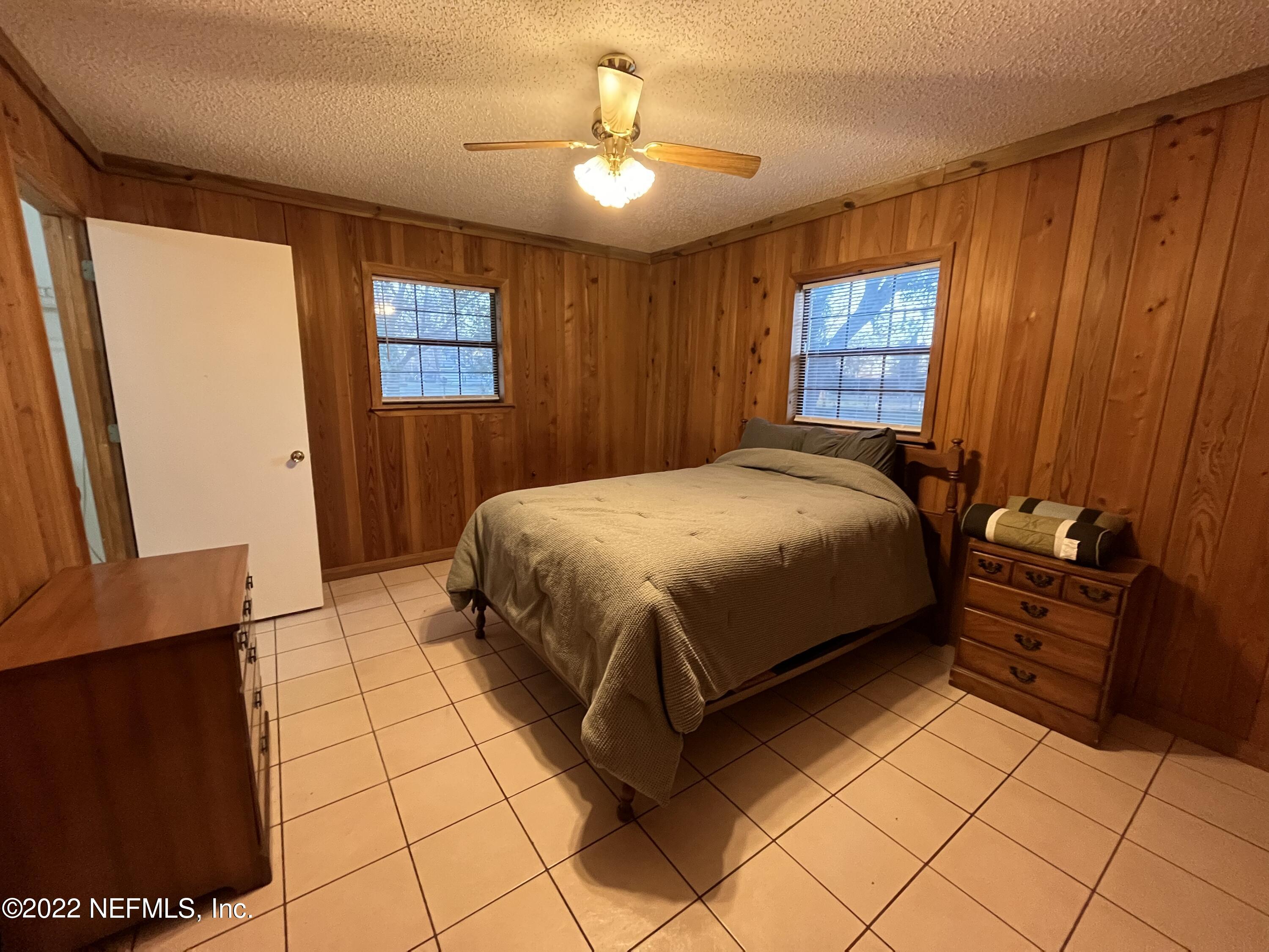 75049 Edwards Road Yulee, FL 32097 - Photo 12 of 23 a bedroom with a bed and a dresser