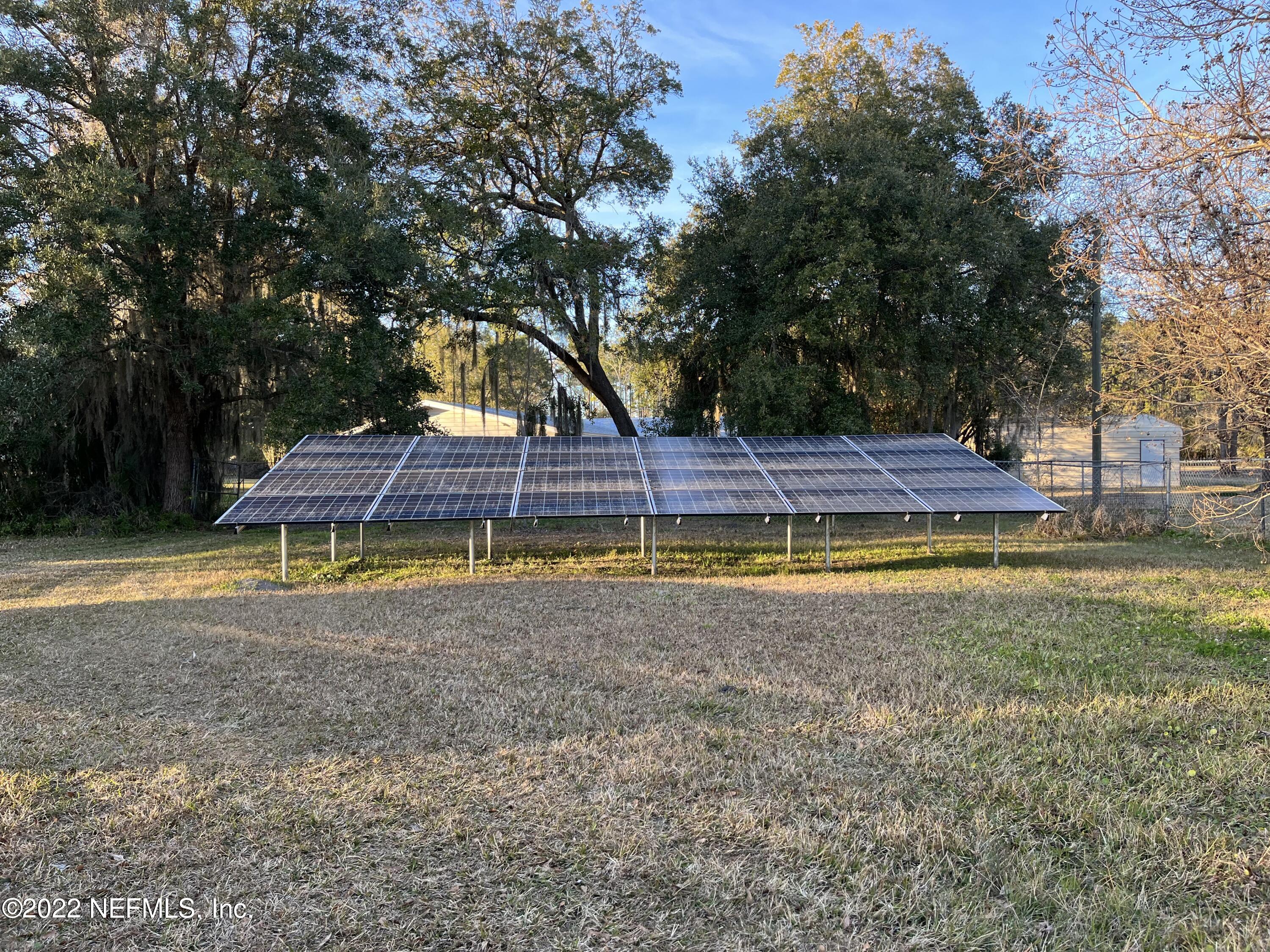 75049 Edwards Road Yulee, FL 32097 - Photo 19 of 23 a view of swimming pool with umbrella and trees in the background