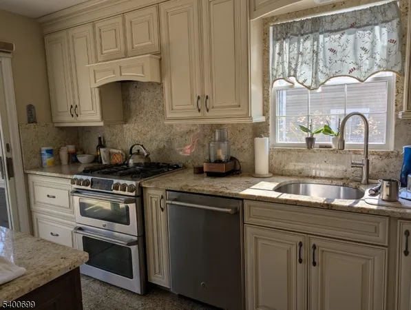a bathroom with a granite countertop sink mirror vanity and bathtub